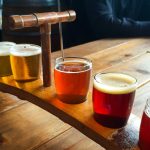 Wooden Tray Holding 6 Different Types Of Beers