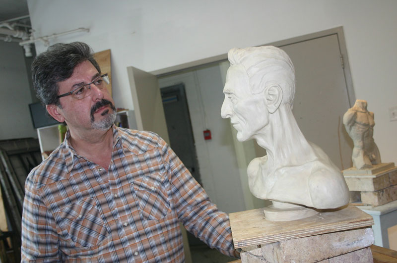 Aldo Cundari In His Art Studio Looking At Sculpture