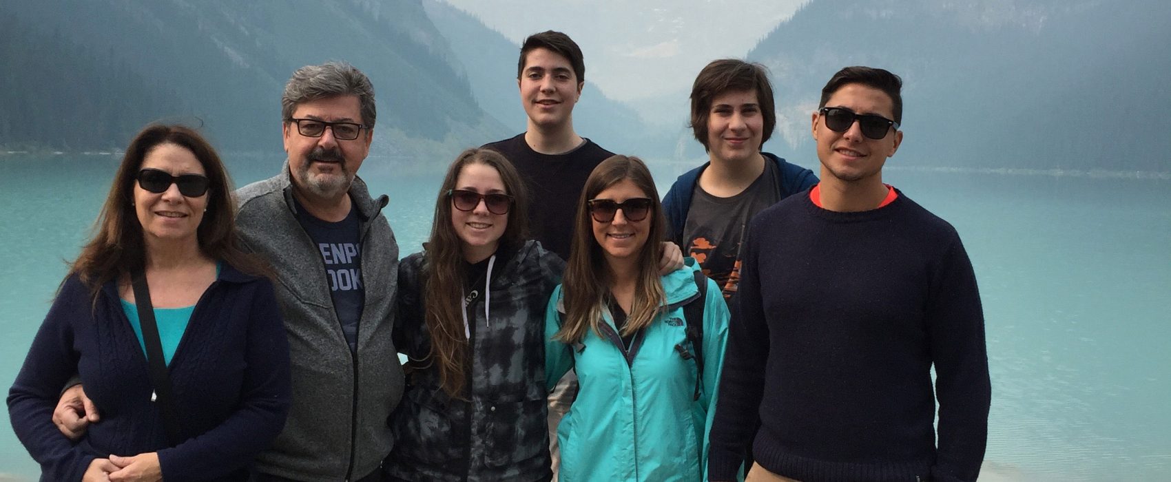 Aldo Cundari With Family With Big Mountains And Lake In The Background