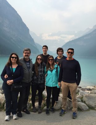 Aldo Cundari With Family With Big Mountains And Lake In The Background