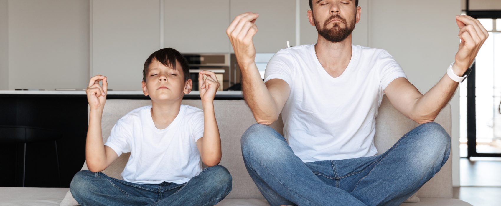 Father And Son Meditating In Kitchen