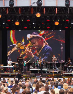 Jazz Concert With Audience Looking At Performer On Stage