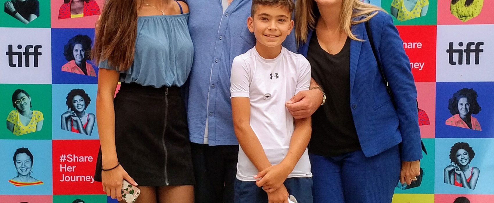 John Vellinga With His Wife Katherine And Children In Front Of Tiff Poster