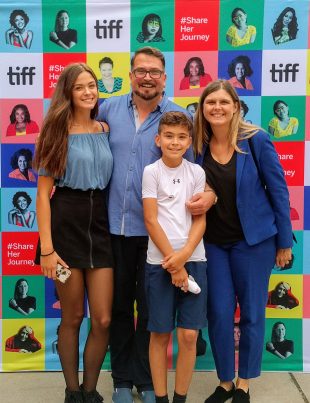 John Vellinga With His Wife Katherine And Children In Front Of Tiff Poster