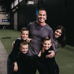 Jason Batt Smiling And Hugging His Children