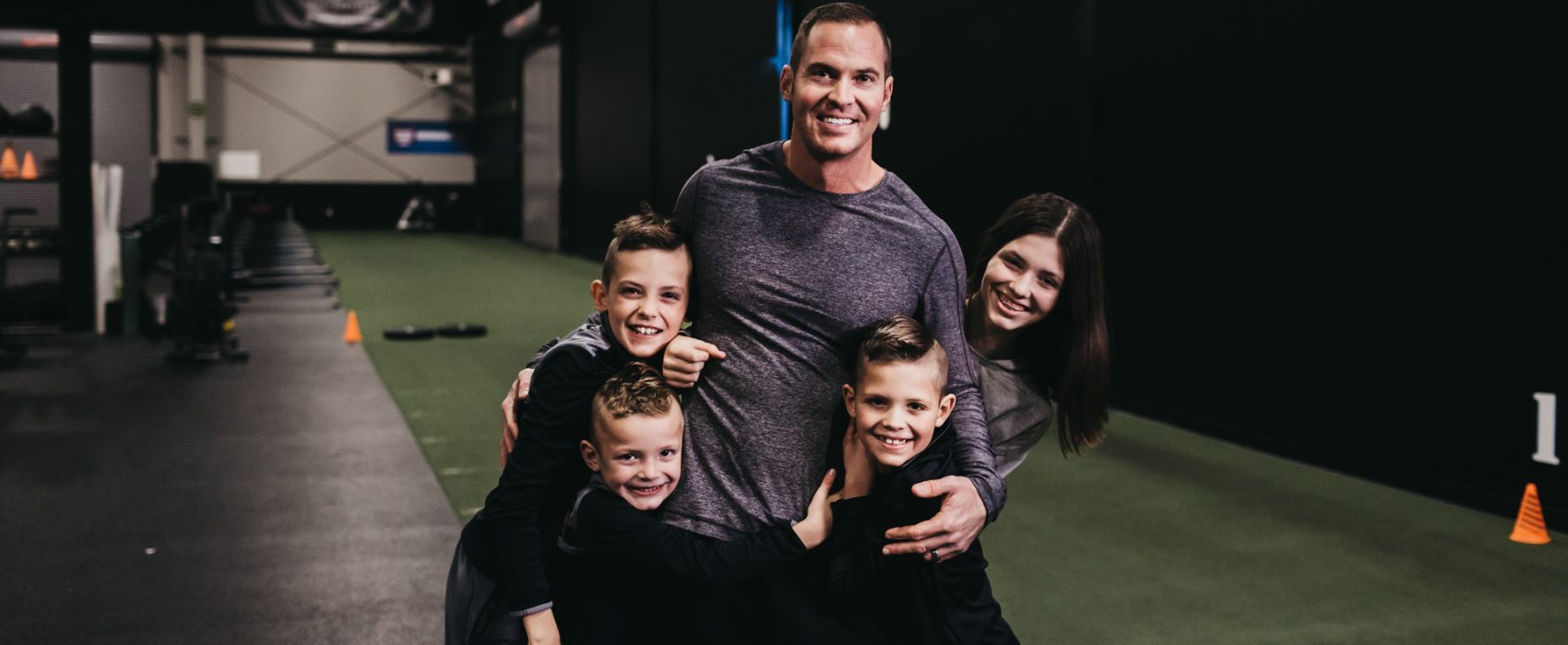 Jason Batt Smiling And Hugging His Children