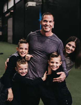 Jason Batt Smiling And Hugging His Children