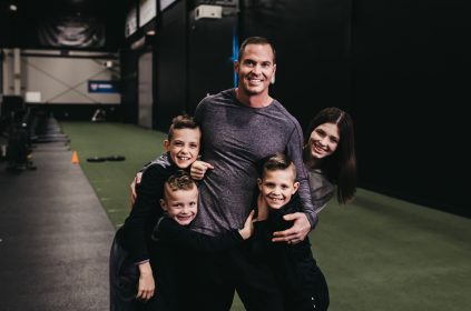 Jason Batt Smiling And Hugging His Children