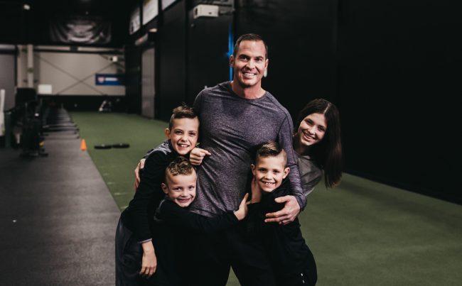 Jason Batt Smiling And Hugging His Children