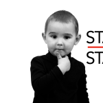 Black And White Photo Of Young Boy Steve Jobs Look-A-Like With Hand Under Chin In Black Turtle Neck Shirt