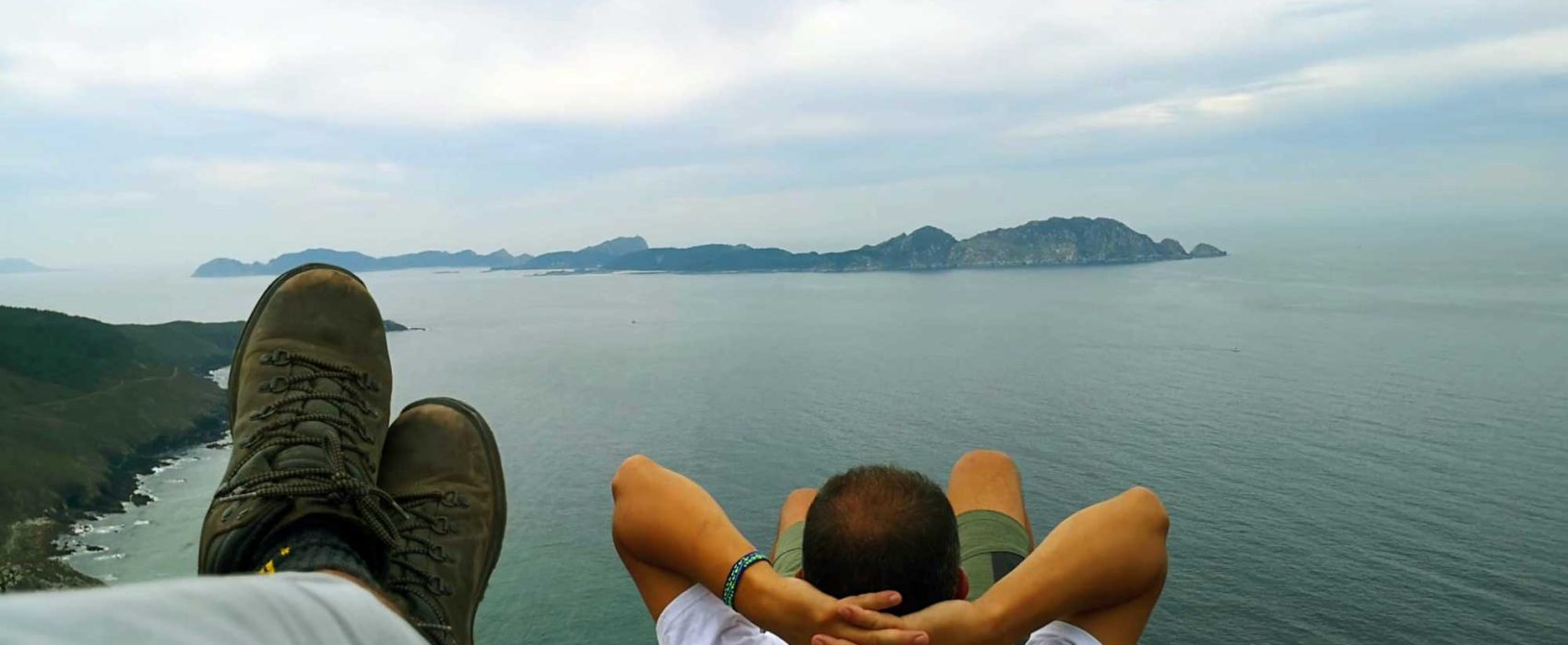 Person Relaxing On His Back Overlooking Atlantic Ocean On The Spanish Coast