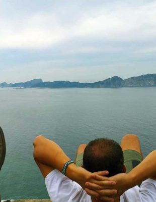 Person Relaxing On His Back Overlooking Atlantic Ocean On The Spanish Coast