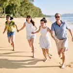 Steven Fisher Running On Beach With His Wife And Children