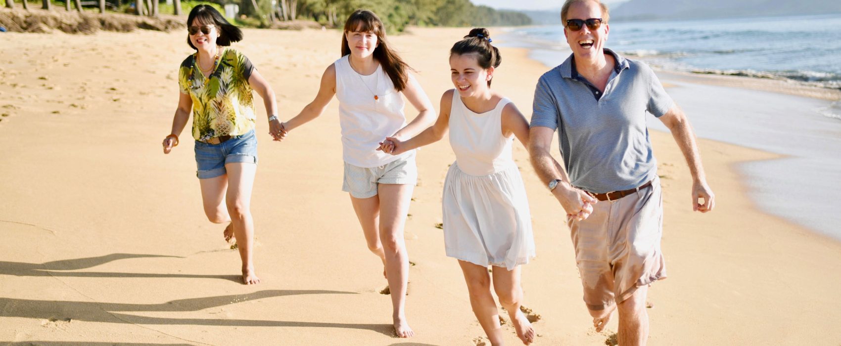 Steven Fisher Running On Beach With His Wife And Children