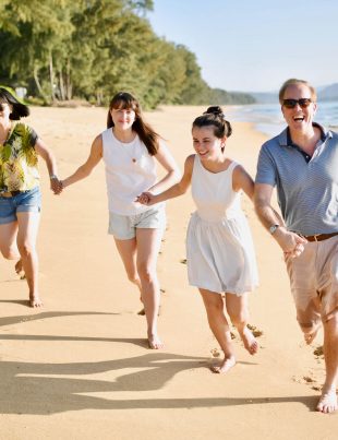 Steven Fisher Running On Beach With His Wife And Children