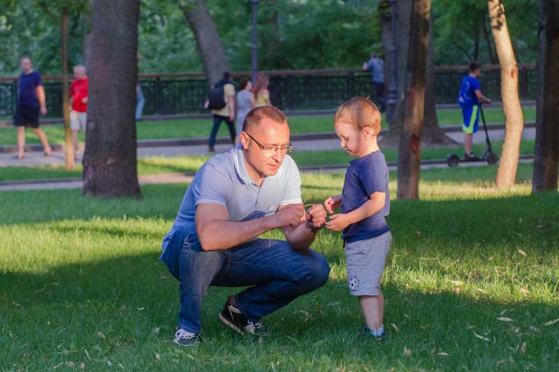 Vasyl Myroshnychenko Kneeling And Shaking To His Son Yuriy In Park