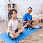 Father And Son Performing Yoga Together