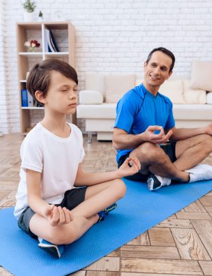 Father And Son Performing Yoga Together