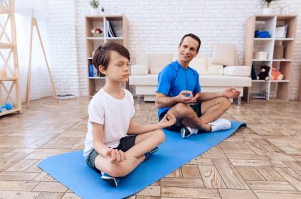 Father And Son Performing Yoga Together