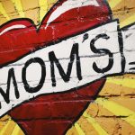 Heart With Word MOMs Across Heart Painted On Brick Wall
