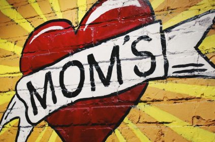Heart With Word MOMs Across Heart Painted On Brick Wall