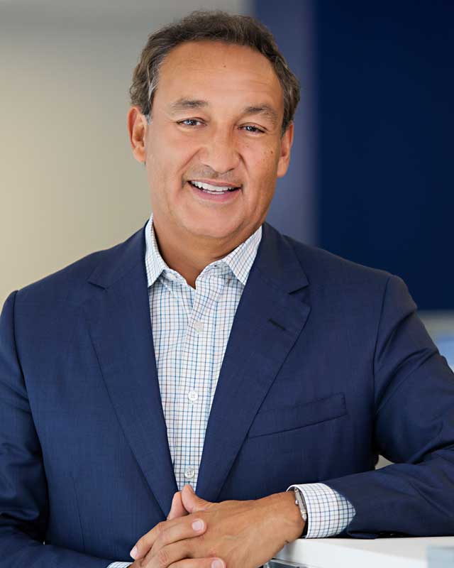 Oscar Munoz In Blue Business Suit Posing For Corporate Photo