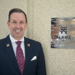 Robert Marks Chef Concierge Of Omni Hotel San Diego Standing Next to Clefs D'Or International Sign