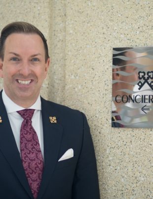 Robert Marks Chef Concierge Of Omni Hotel San Diego Standing Next to Clefs D'Or International Sign