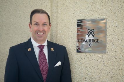 Robert Marks Chef Concierge Of Omni Hotel San Diego Standing Next to Clefs D'Or International Sign